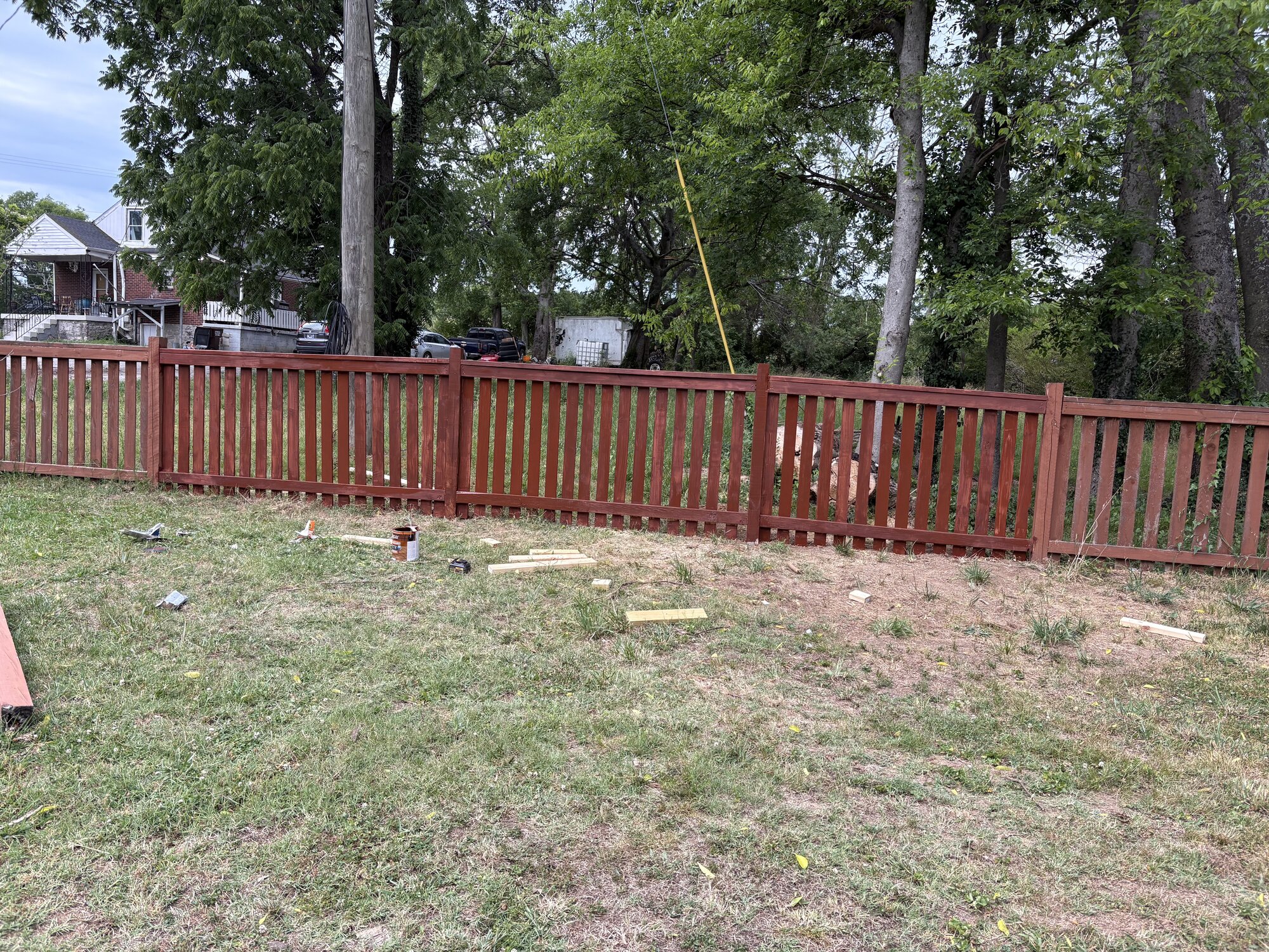 Freshly edged lawn along a residential fence line